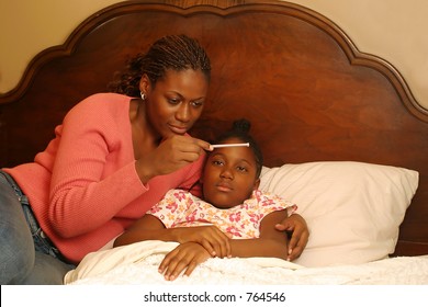 A Mother With A Sick Child Reading The Thermometer.