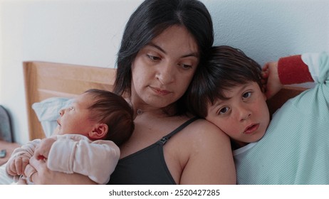 Mother sits with her baby and older child showcasing a serene and intimate family moment The baby sleeps peacefully in her arms while the older sibling rests against her reflecting familial love and - Powered by Shutterstock