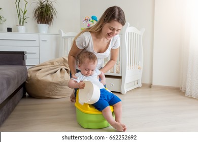 Mother Sitting Her Baby On Chamber Pot