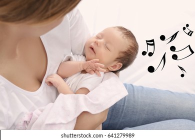 Mother With Sleeping Baby At Home. Lullaby Songs And Music Concept