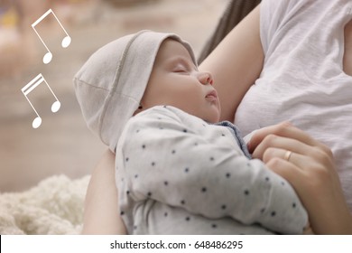 Mother With Sleeping Baby At Home. Lullaby Songs And Music Concept