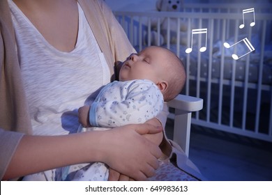 Mother With Sleeping Baby At Home. Lullaby Songs And Music Concept