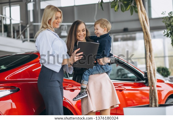 Mother with son buying a\
car