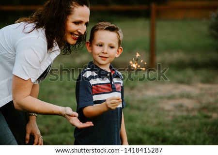 Mother and son celebrating with sparkler fireworks