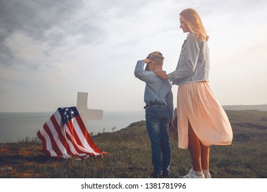 mother with son in the cemetery near the grave of the father of the American soldier who died in the ridge point defending the sovereignty and independence of the United States of America