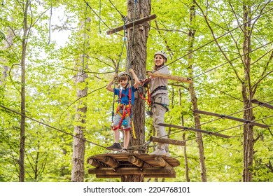 Mother and son climbing in extreme road trolley zipline in forest on carabiner safety link on tree to tree top rope adventure park. Family weekend children kids activities concept Portrait of a - Powered by Shutterstock