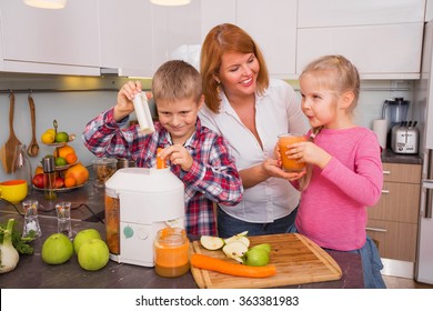 Mother, son and daughter making fresh juice in kitchen  - Powered by Shutterstock