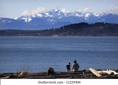 Mother and Son in the distance at the Beach, Edmonds, Snohomish County, Washington with Olympic Mountains in Background