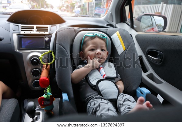 mother and son drive road
trip family travel in summer vacation day, cute baby boy sitting on
car seat