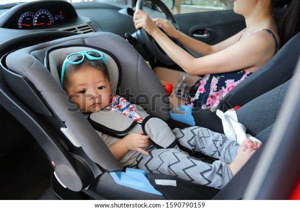 mother and son drive road\
trip family travel in summer vacation day, cute baby boy sitting on\
car seat