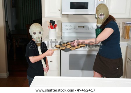 a mother and son enjoy hot fresh baked cookies in their kitchen while wearing gas masks in a post nuclear future