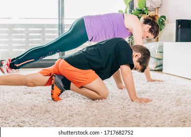 Mother And Son Exercising With A Virtual Class On Tv