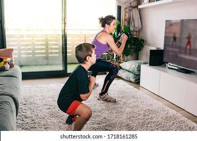 Mother And Son Exercising With A Virtual Class On Tv