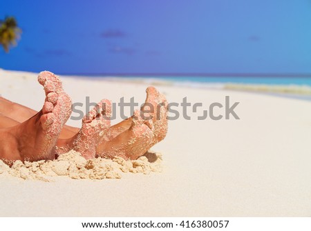 mother and son feet on summer beach