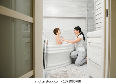 Mother And Son Having Fun At Bath Time Together