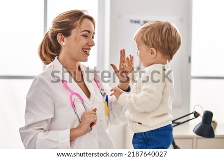 Mother and son having pediatrician consultation and playing at clinic