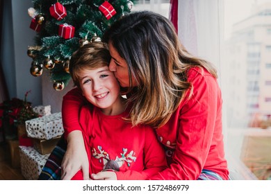 Mother And Son At Home Wearing Matching Pajamas. Christmas Season