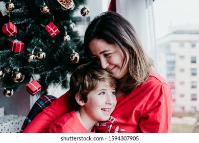 Mother And Son At Home Wearing Matching Pajamas. Christmas Season