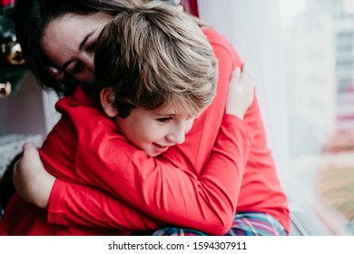 Mother And Son At Home Wearing Matching Pajamas. Christmas Season