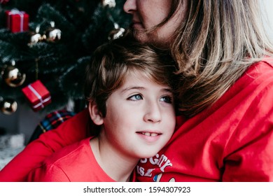 Mother And Son At Home Wearing Matching Pajamas. Christmas Season