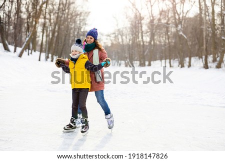 Mother and son ice skating
