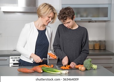 Mother and Son in the kitchen. A beautiful woman in the kitchen with her teenage son.