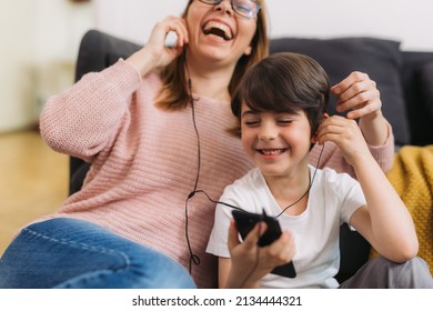 mother and son listening to a music at home - Powered by Shutterstock