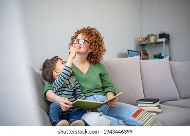 Mother And Son In Living Room Spend Some Quality Time. Mom And Son Reading Fairy Tales In Bed. Reading With Mum At Home. Little Boy And His Mother Are Reading A Book Together