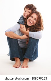 Mother And Son In A Loving Pose Isolated On A White Background.