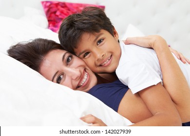 Mother And Son Lying In Bed Together