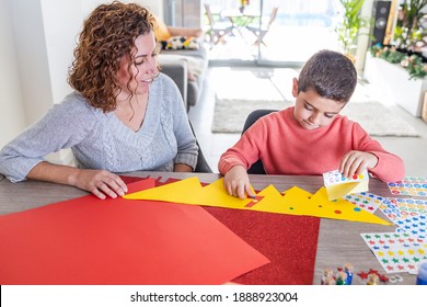 Mother And Son Making Crafts At Home With Cardstocks And Stickers