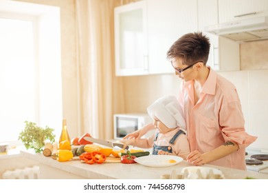 Mother And Son Making Salad At Kitchen Home.