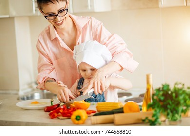 Mother And Son Making Salad At Kitchen Home.