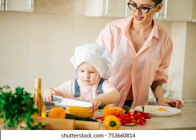 Mother And Son Making Salad At Kitchen Home.