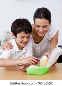 Mother And Son Making The School Lunch In The Kitchen