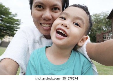 Mother And Son Making Selfie With A Stick