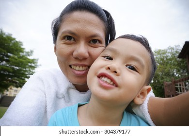 Mother And Son Making Selfie With A Stick