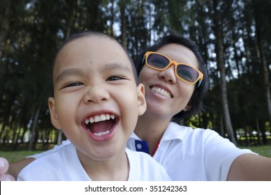 Mother And Son Making Selfie With A Stick