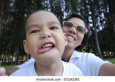 Mother And Son Making Selfie With A Stick