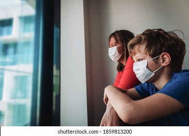 mother and son with masks stay home, family looking at the window