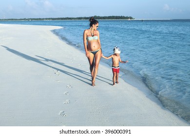 Mother And Son On The Beach. Second Pregnancy 