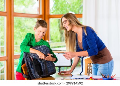 Mother And Son Packing School Bag For Next Day
