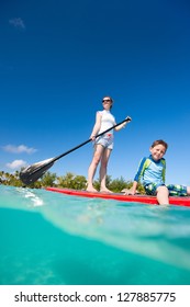 Mother And Son Paddling On Stand Up Paddle Board At Tropical Ocean