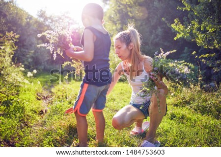 Similar – Image, Stock Photo little boy picks flowers in the garden