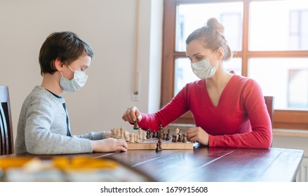 Mother And Son Playing Chess To Kill Some Time During Curfew In Crises At Home