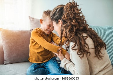 Mother and son playing in a living room. Spending quality time togather. Mother and son laughing. Exited mom and son are entertaining in living room. Parents are playing with children at home concept - Shutterstock ID 1681660333