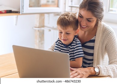 Mother And Son Playing On A Computer