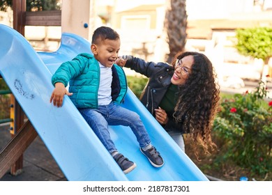 Mother and son playing on slide at park - Powered by Shutterstock