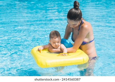 Mother and son playing in the pool. - Powered by Shutterstock