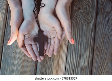 Mother And Son Praying Together And Holding Old Wooden Rosary. Family Prayer